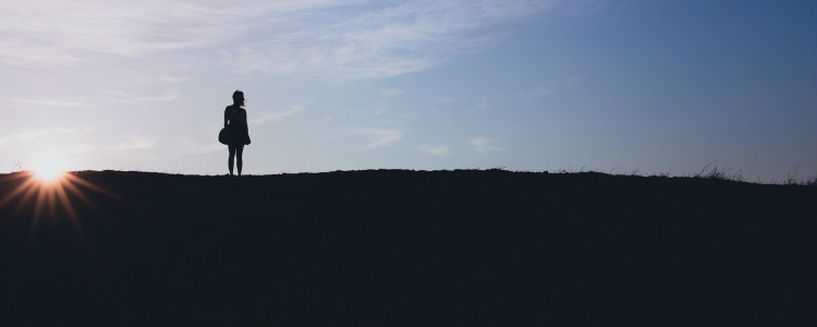 Girl Standing on Hill
