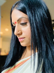 Priya wearing a sari and bindi on center of forehead
