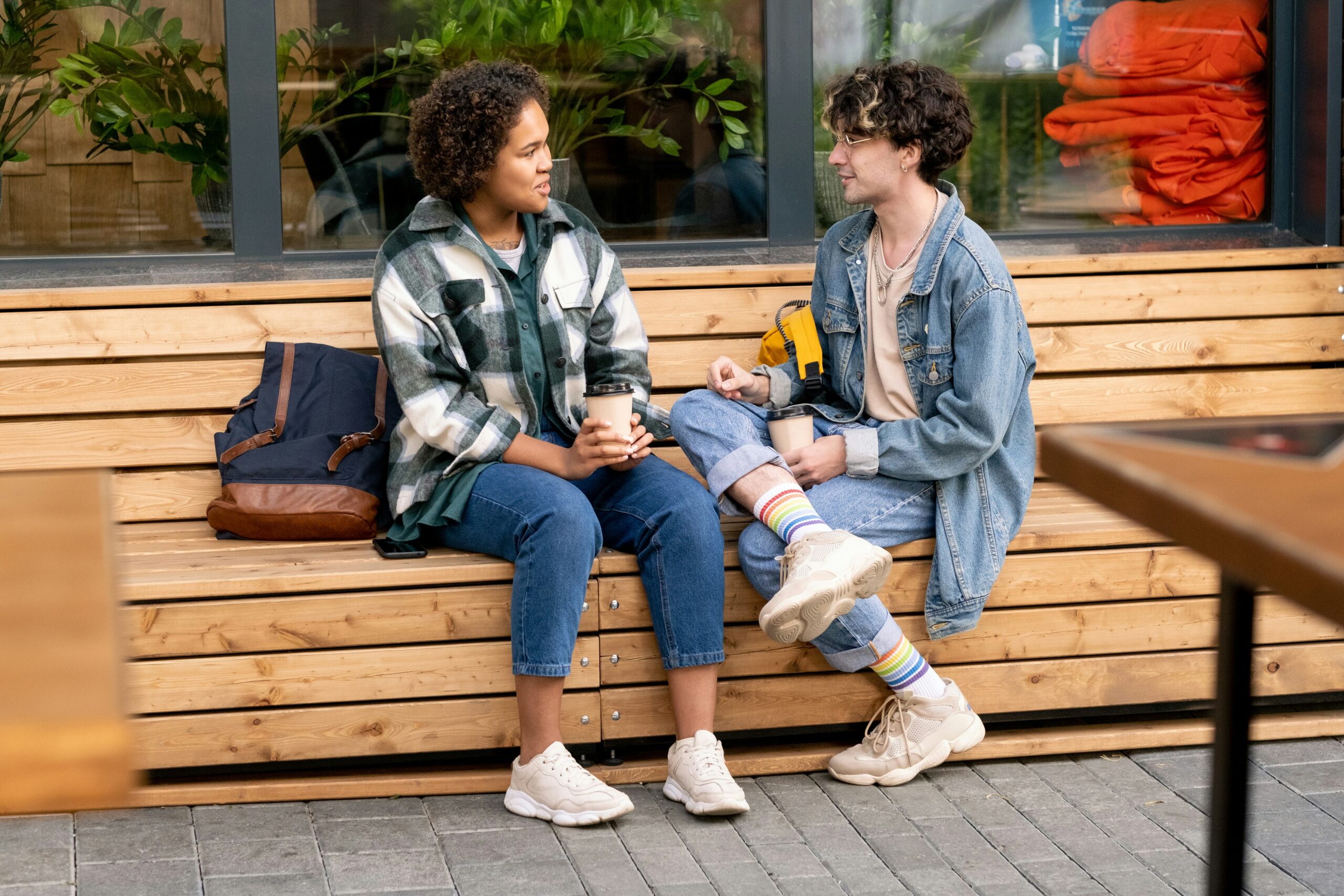 Two friends talking on a bench