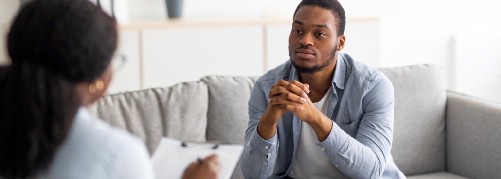 Man talking with therapist about eating disorder and body dysmorphic disorder